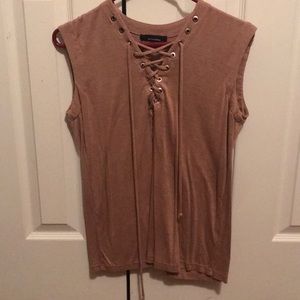 Sleeveless tie up shirt.